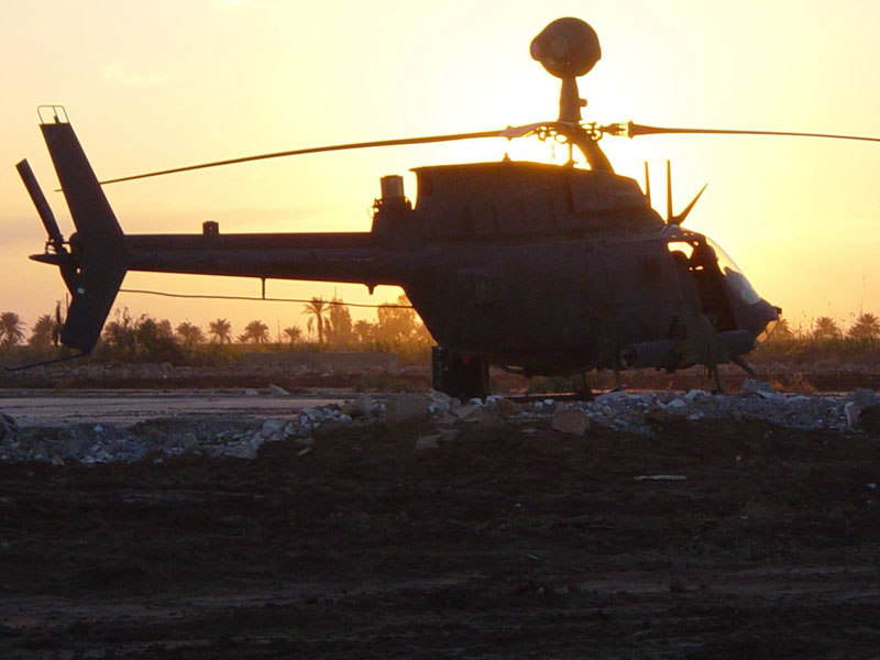 US Army helicopter with a sunset backdrop.